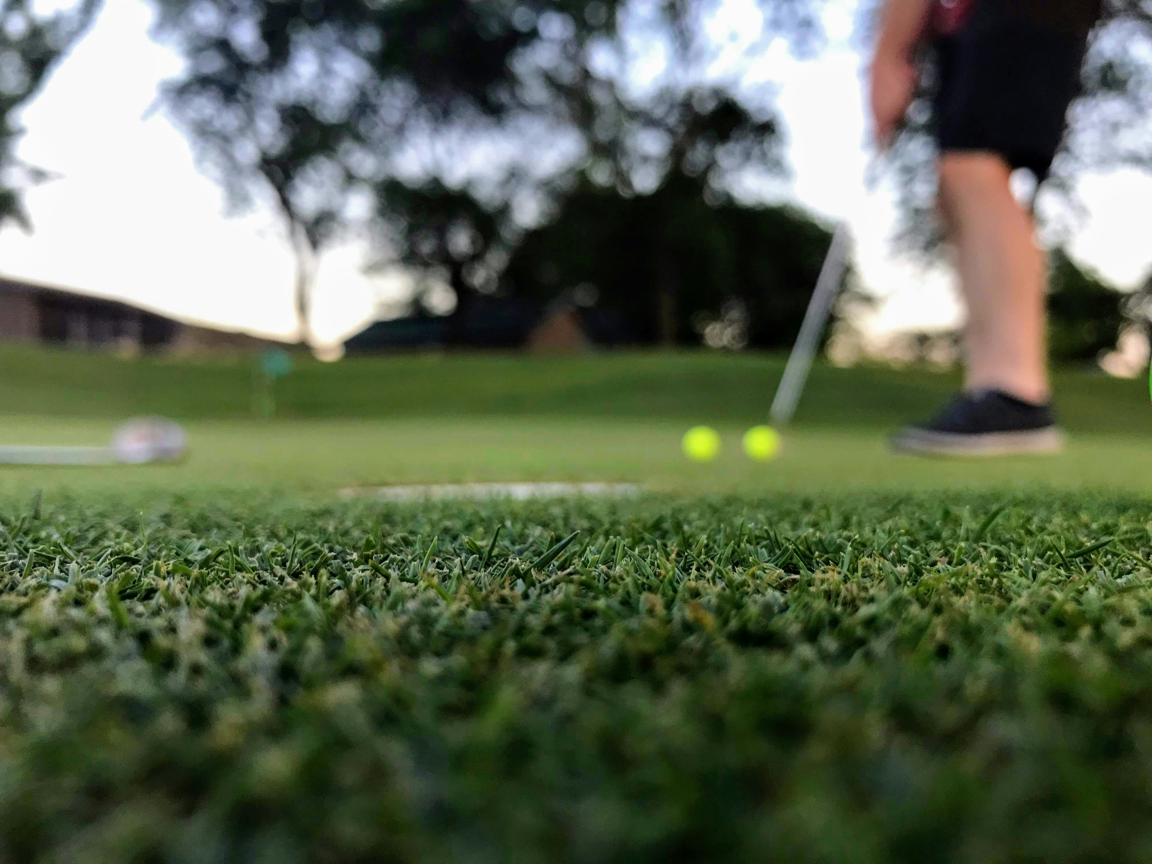 Professional Asian golfer demonstrating perfect swing technique and form